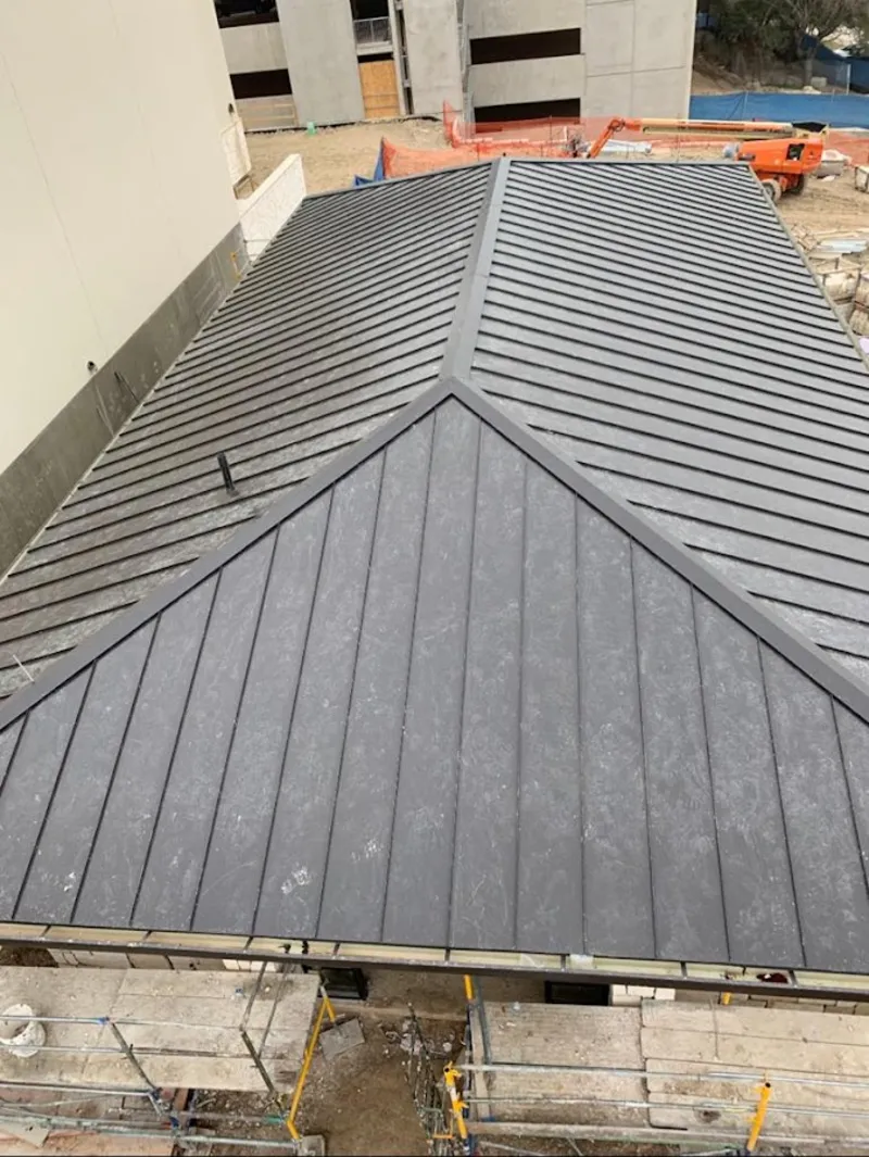 Commercial metal roof construction with crane equipment in Chehalis